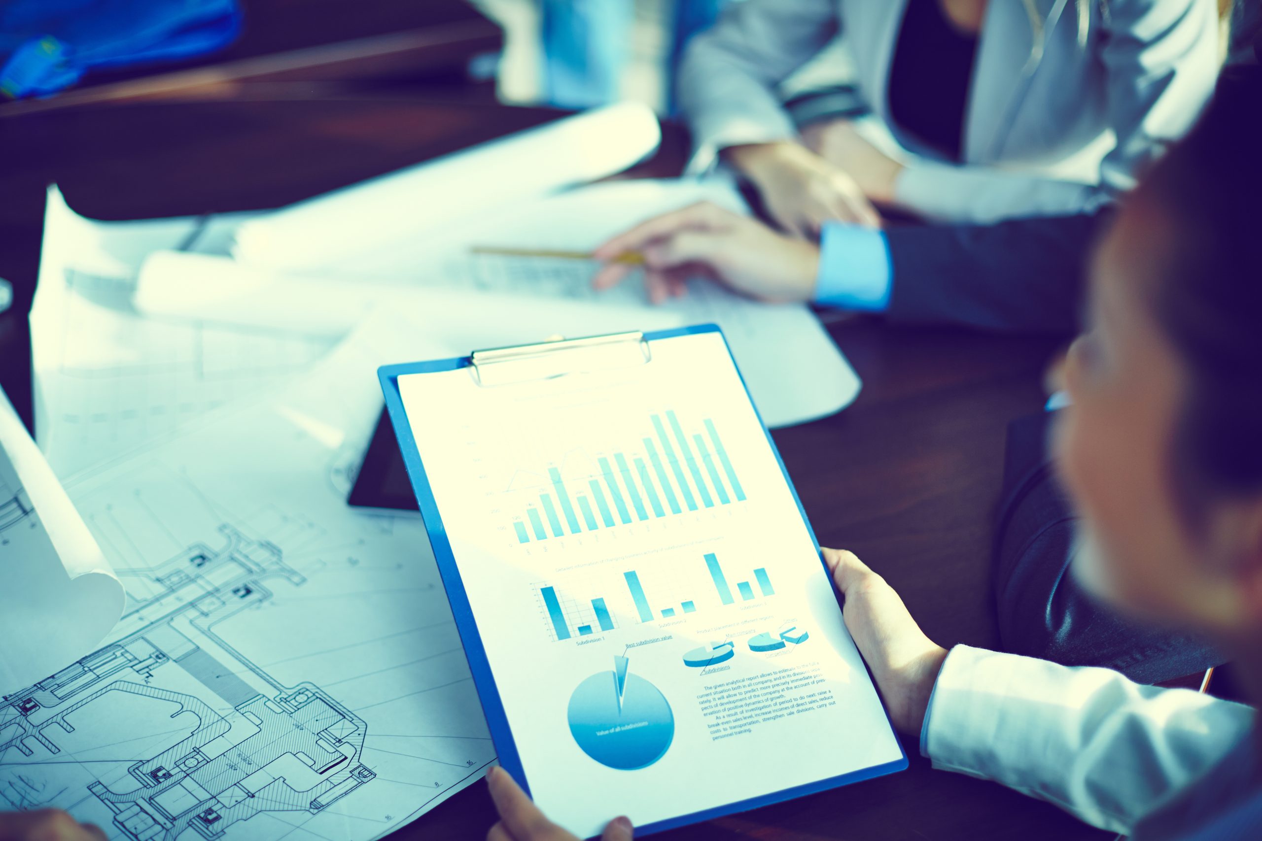 Close up businessman analyzing annual report scaled