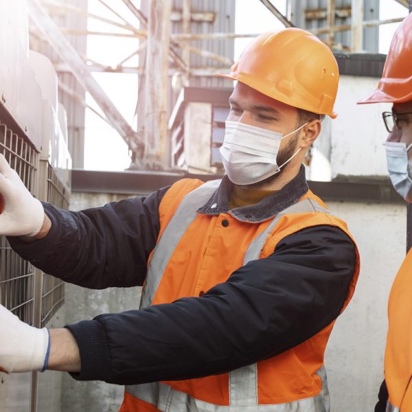 Close up men with masks working together 600x600